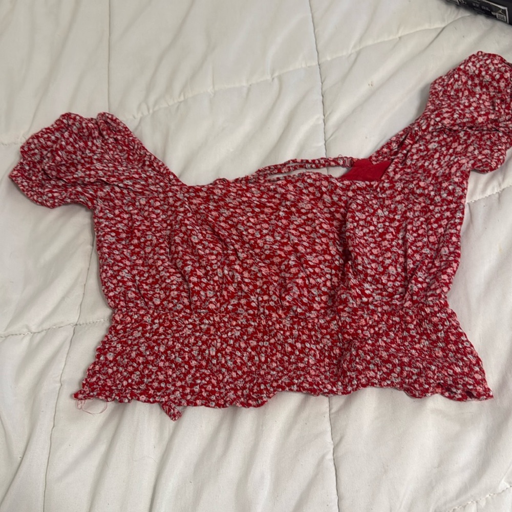 Red floral top with tie in the back and cuffed sleeves. A-little cropped.